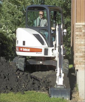 Mini digger performing offset digging